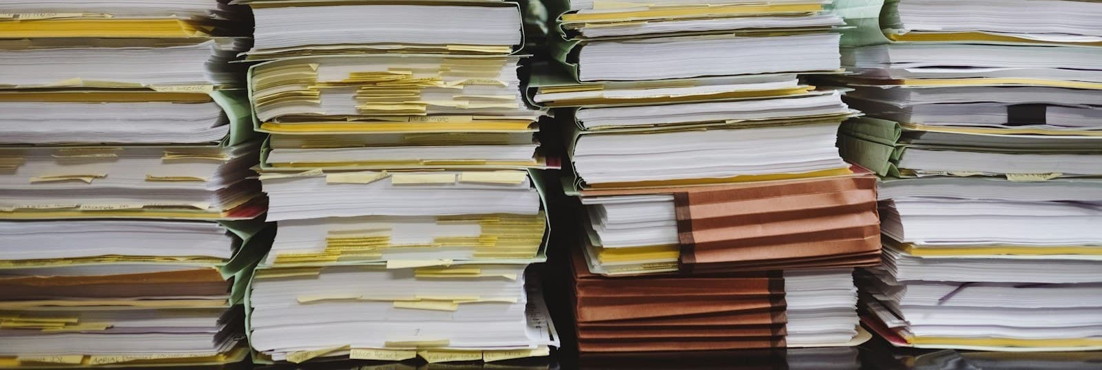 Stacks of paper documents and file folders